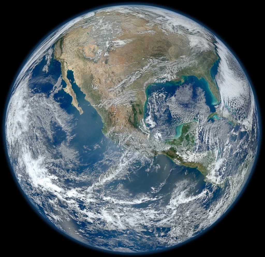 NASA Blue Marble image of Earth, with swirling clouds over the Pacific and the Americas